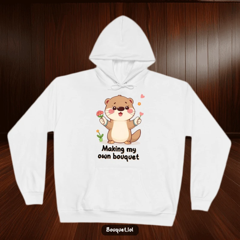 Funny hoodie with a playful otter wearing gardening gloves, tossing a small bouquet of flowers, spreading happiness and garden cheer.
