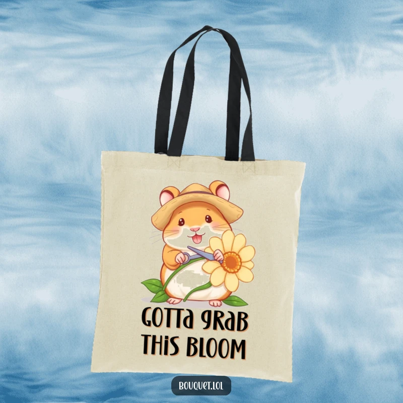 Funny tote bag featuring a cheerful hamster gardener with a straw hat and tiny scissors, ready to snip a large flower stem, botanical humor.